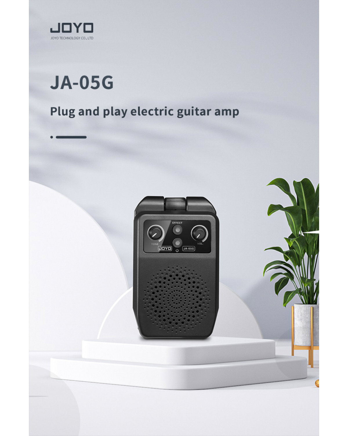 Haze Guitar Australia Joyo JA05G portable electric guitar mini amp with tone and volume controls on a white pedestal