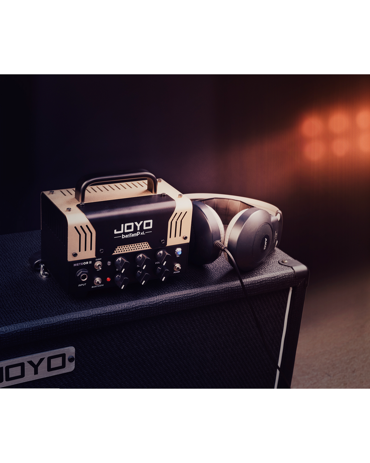 Haze Guitar Australia Joyo METEORII 20w tube guitar amplifier head with headphones on a speaker cabinet