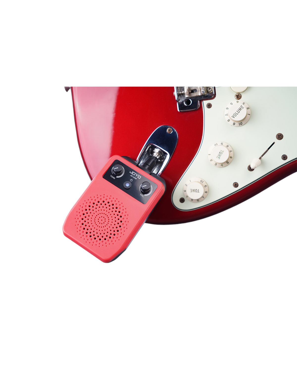 Haze Guitar Australia Joyo JA05W portable mini amplifier plugged into a red electric guitar for practice