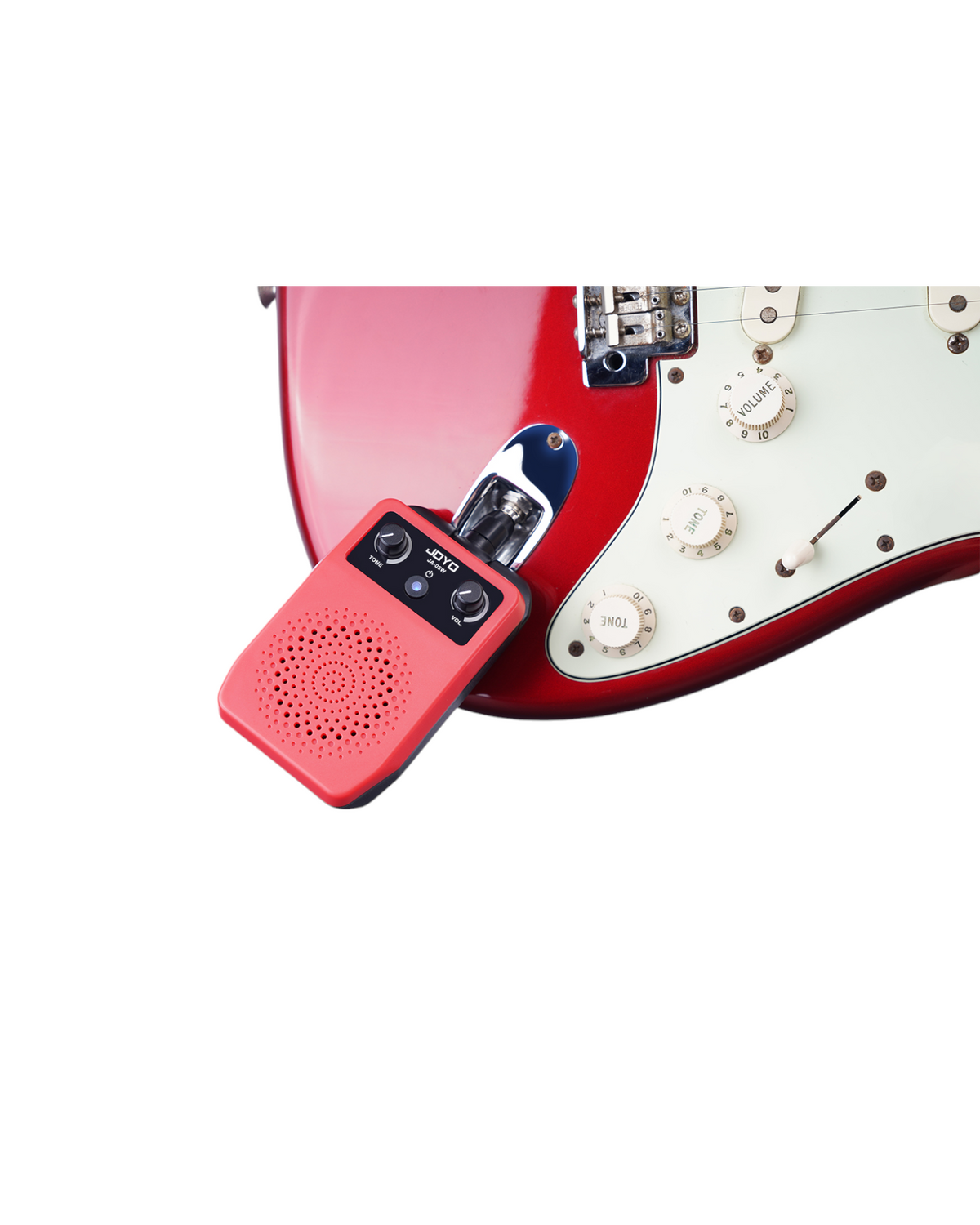 Haze Guitar Australia JOYO JA05W red portable mini amplifier plugged into a red electric guitar for practice